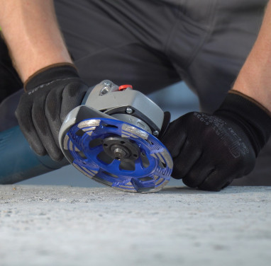 Grinding of construction materials with an angle grinder.